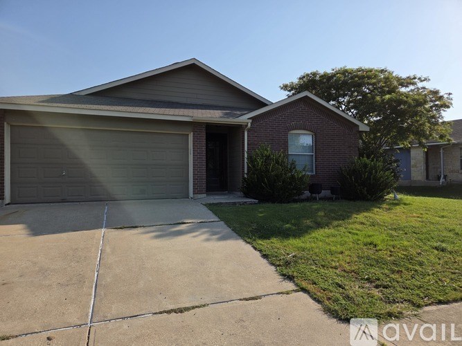 A house with a garage door is for sale.
