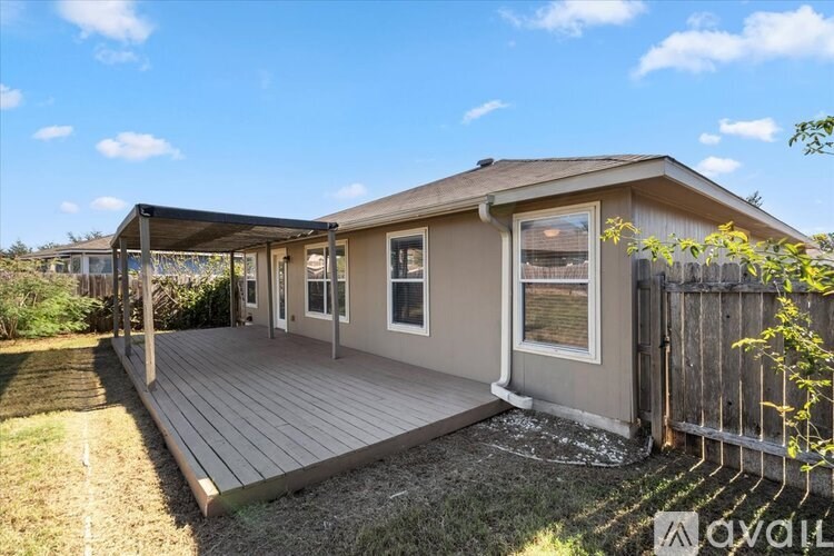 A house with a deck and a fence.