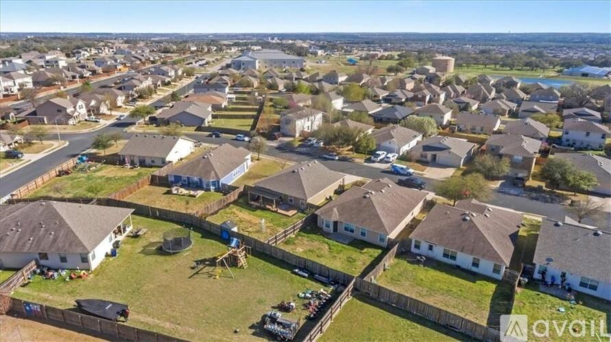 A bird's eye view of a residential area with houses and a playground.