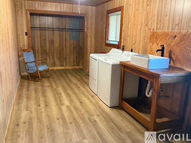 A bathroom with wooden walls and a wooden floor.