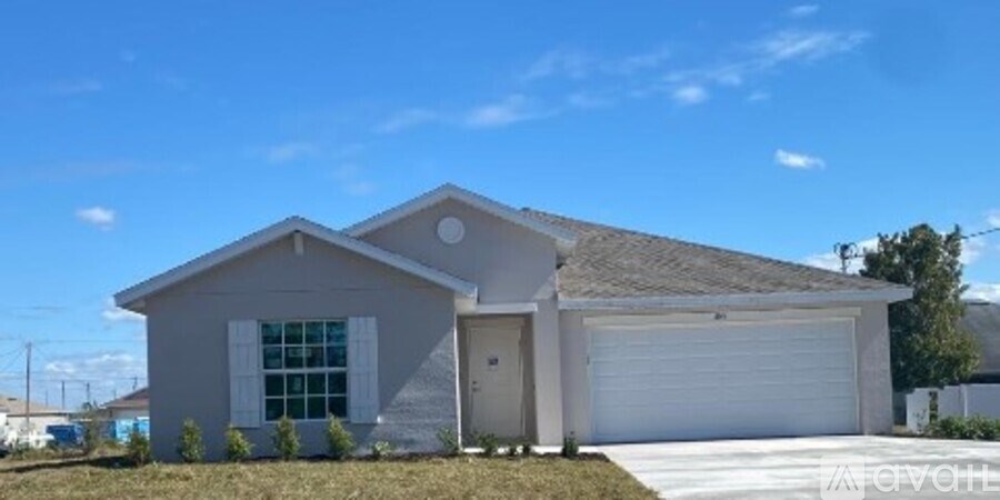 A two-story house with a garage door and a window.