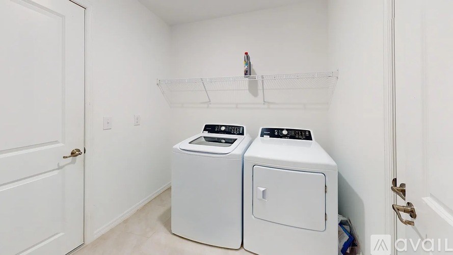 A small laundry room with a washer and dryer.
