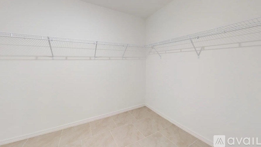 Empty room with a white wall and a shelf.
