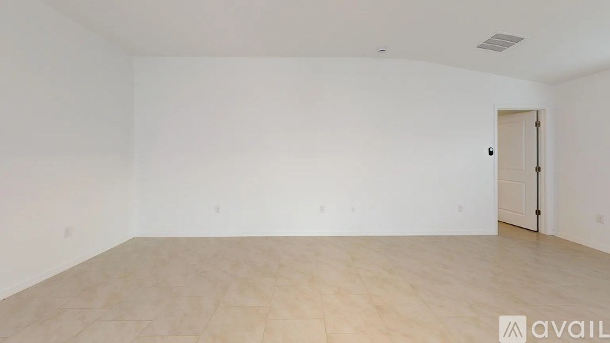 Empty room with wooden floor and white walls.