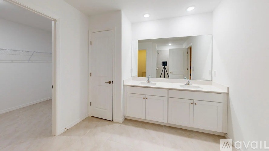 A bathroom with a white cabinet and a mirror.