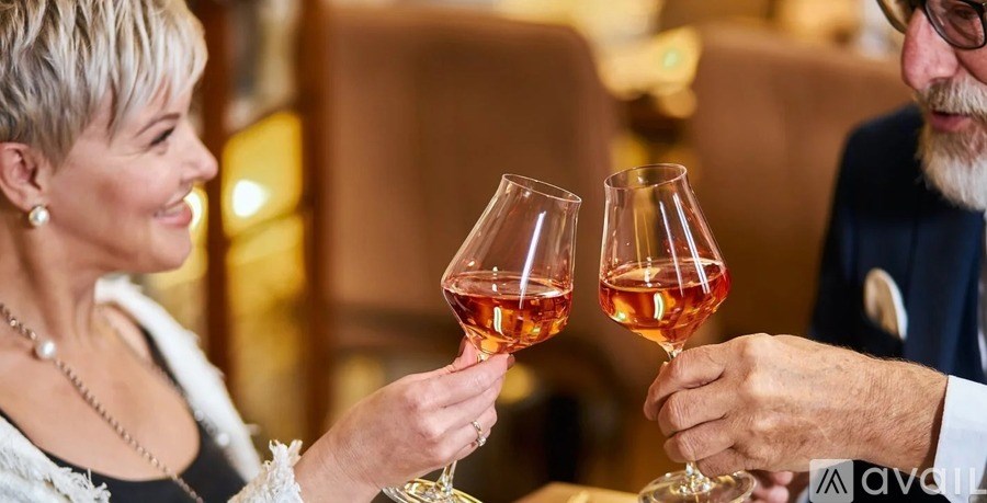 Two people toasting with glasses of wine.