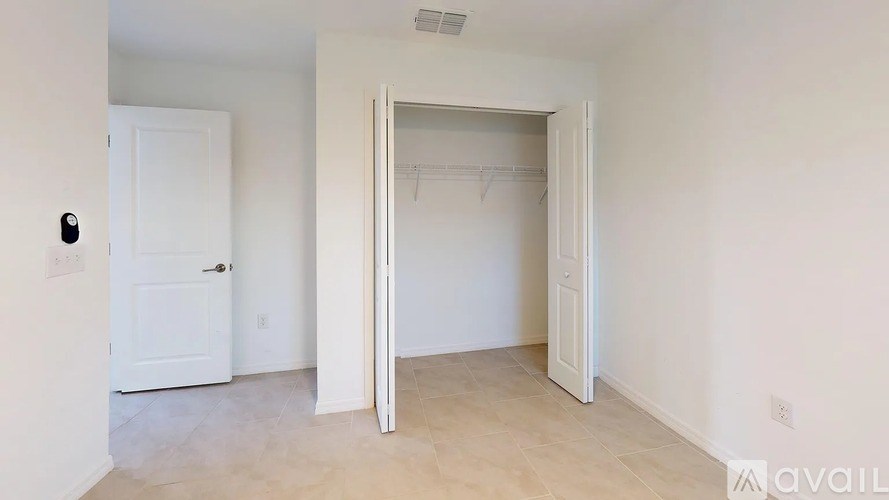 A room with a white door and a white closet door.