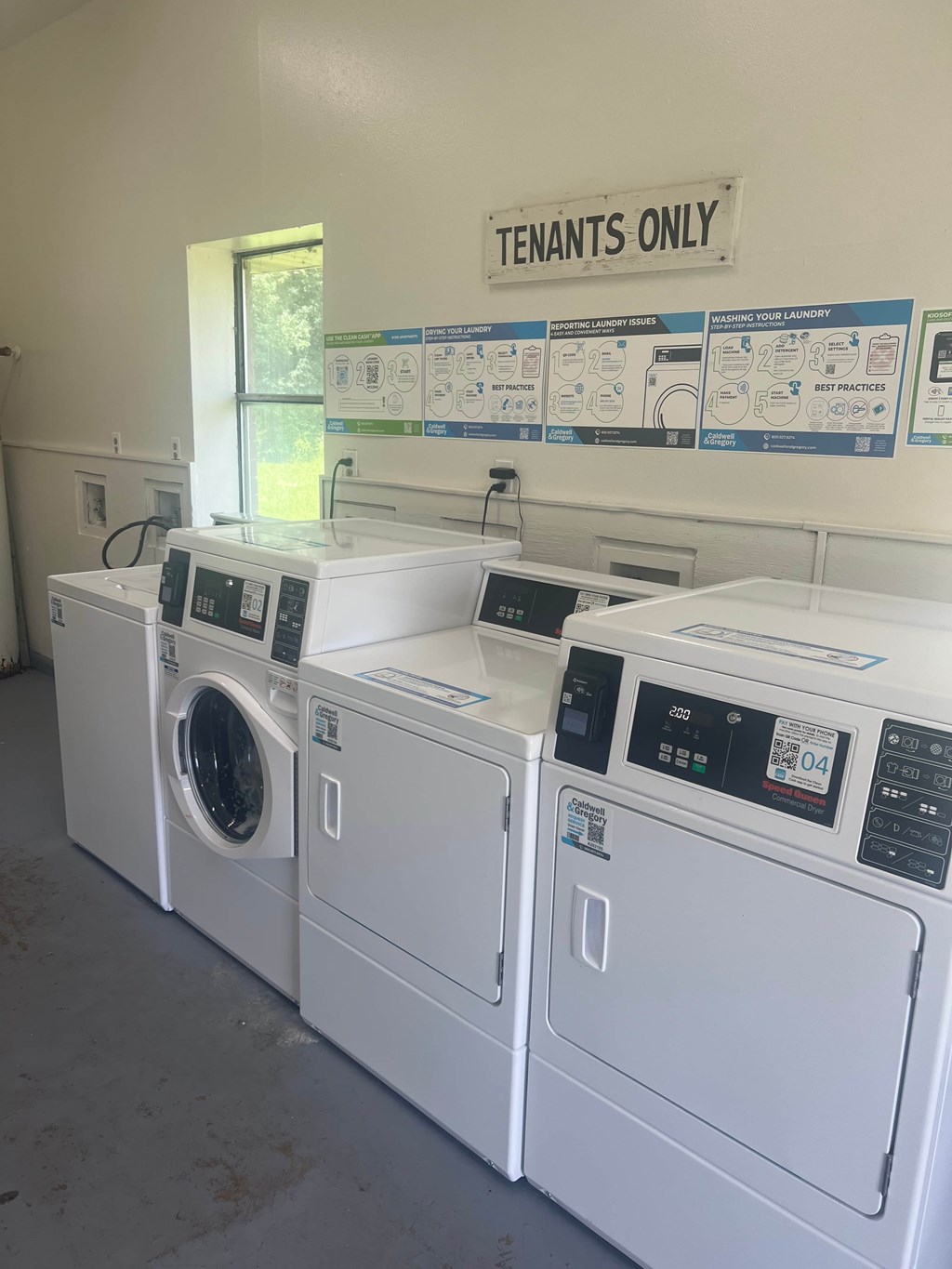 A row of washing machines in a laundromat.