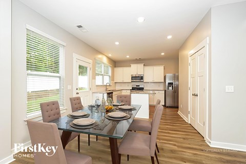 A dining room with a glass table and chairs.