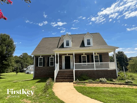 A house with a porch and a sign that says "FirstKey Homes".