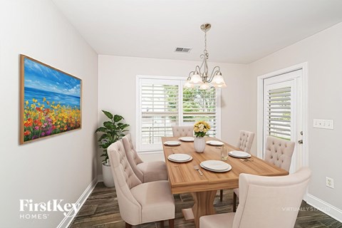 A dining room with a wooden table set for six.