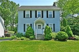 A blue house with a white door and windows.