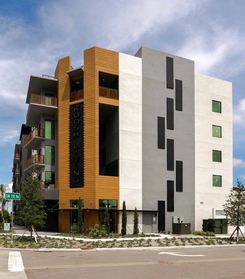 A modern building with the word "KOUSH" on the side.