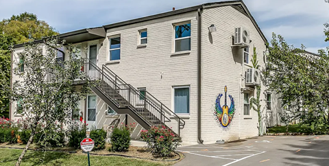 A building with a mural of a bird on its side.