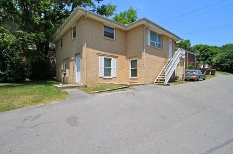 A two-story house with a garage and a driveway.