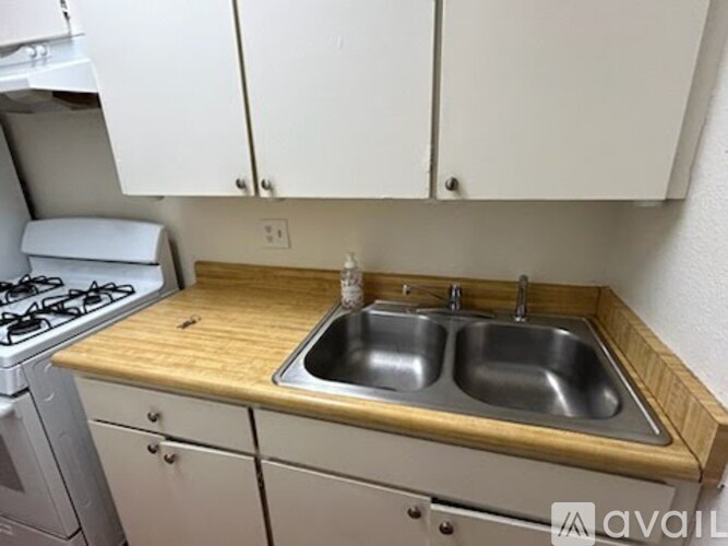 A kitchen with a wooden countertop and a stove.