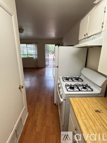 A kitchen with a stove and cabinets.
