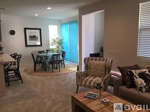 A living room with a brown couch and a coffee table.