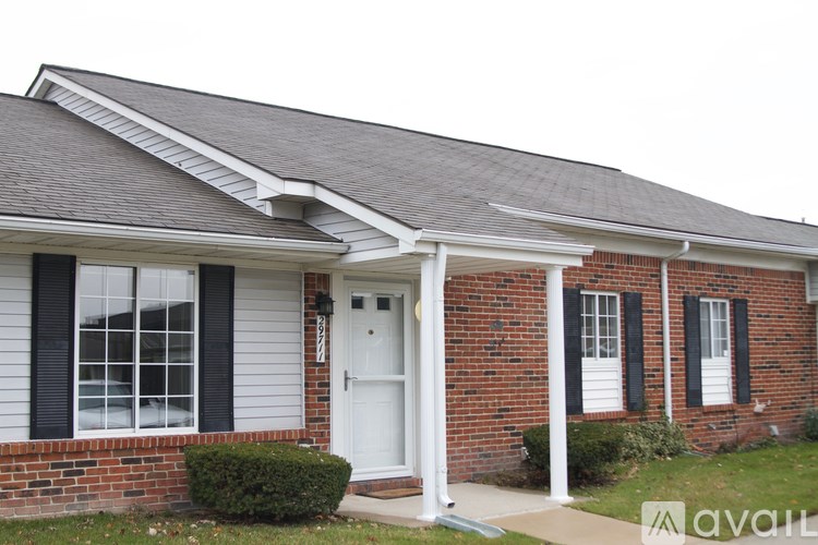 A house with a white door and black shutters.