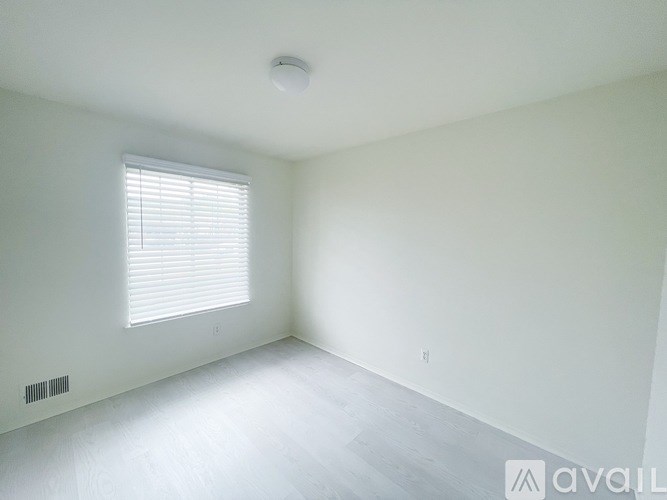 A room with a window and a ceiling light.