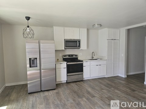 A kitchen with white cabinets and stainless steel appliances.