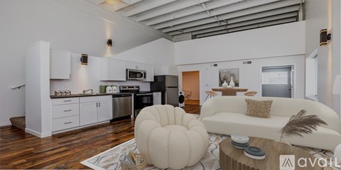 A modern kitchen with white cabinets and a large island.