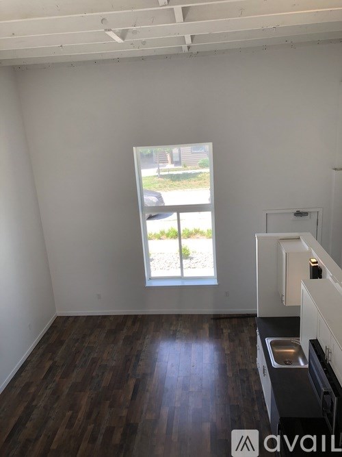 A room with a window and a sink in it.