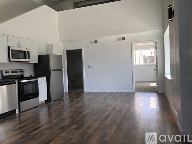 A kitchen with black appliances and white cabinets.