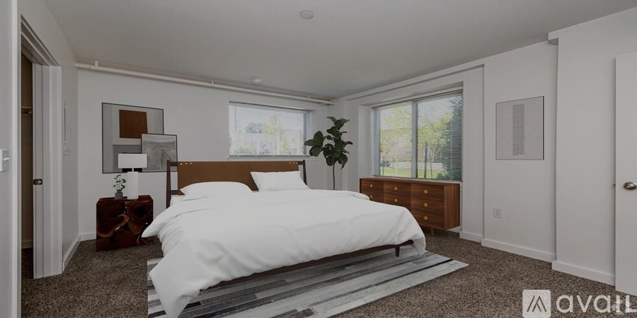 A bedroom with a large bed and a window.