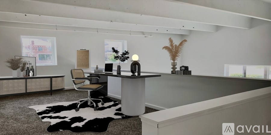 A modern office space with a desk, chair, and a cowhide rug.