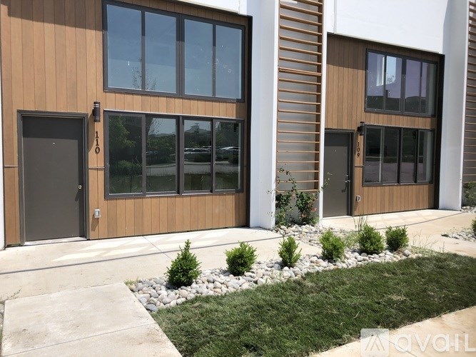 A modern building with wooden sidings and glass windows.
