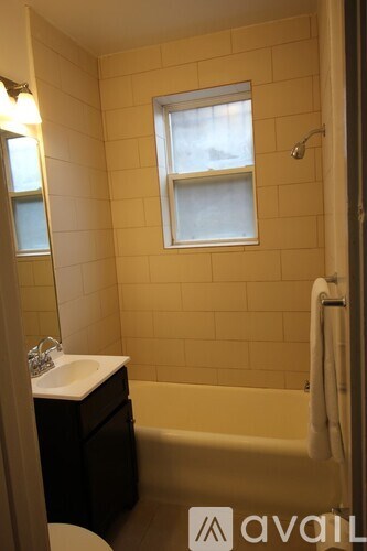 A bathroom with a toilet, sink, and bathtub.