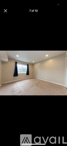 A room with a window and a blue curtain.