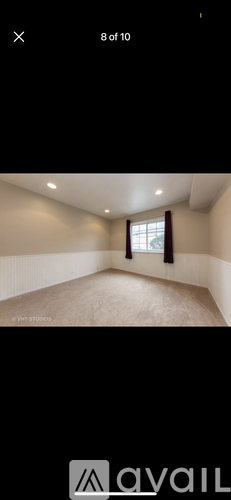 A room with a window and a ceiling fan.