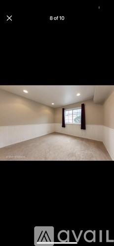 A room with a window and a ceiling fan.