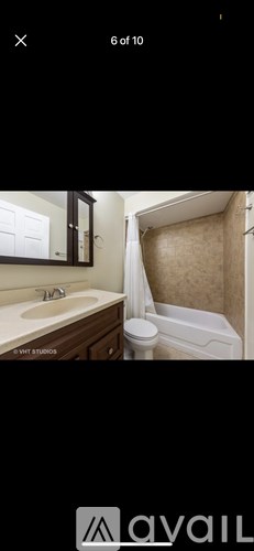 A bathroom with a white toilet and a shower curtain.