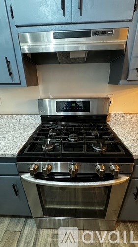 A modern kitchen with a stainless steel stove top and oven.