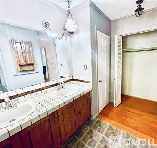 A bathroom with a white sink and a mirror.