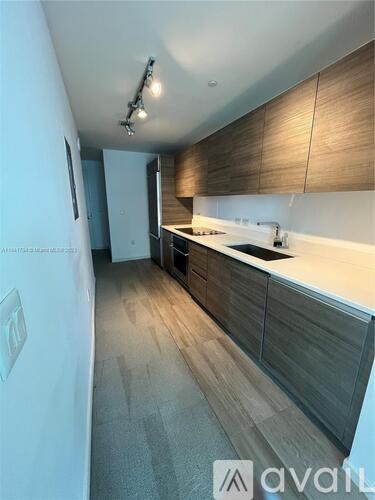 A kitchen with wooden cabinets and a white countertop.