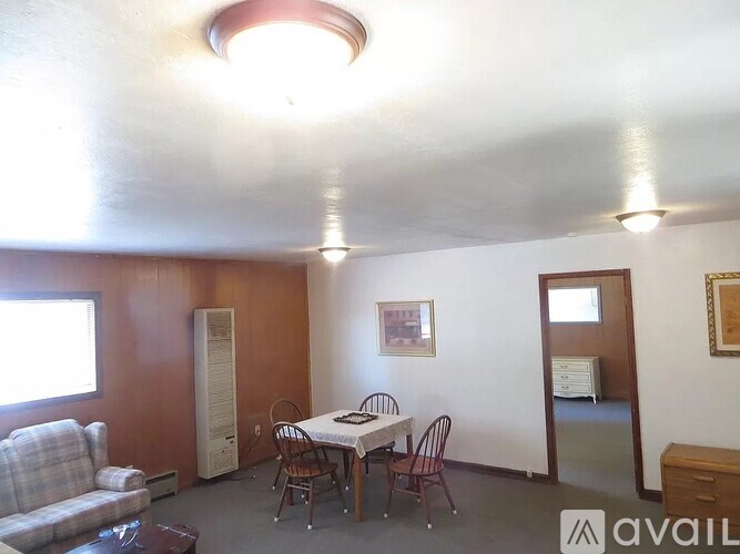 A room with a table and chairs in it.