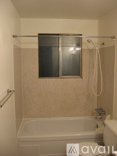 A bathroom with a tub and a shower.
