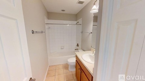 A bathroom with a toilet, sink, and shower.