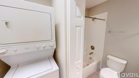 A white oven and toilet in a bathroom.