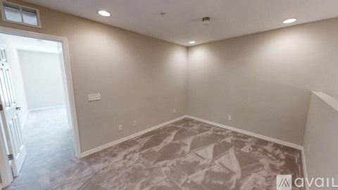 A room with a marble floor and a door leading to another room.