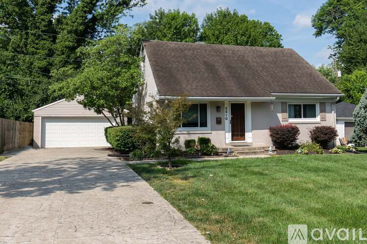 A house with a brown roof and a white garage door.