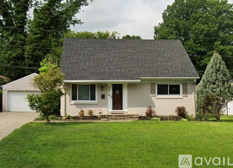 A house with a brown roof and a white garage door.