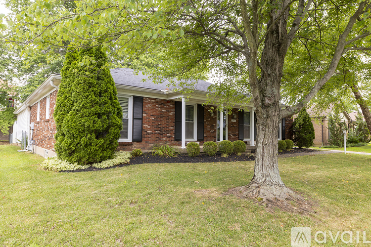 A house with a tree in front of it.
