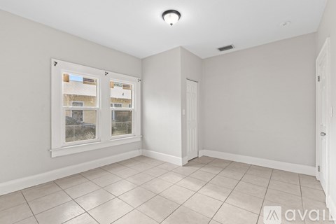 A kitchen with white cabinets and appliances.