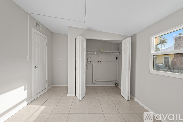 A white door is open to a dark hallway.