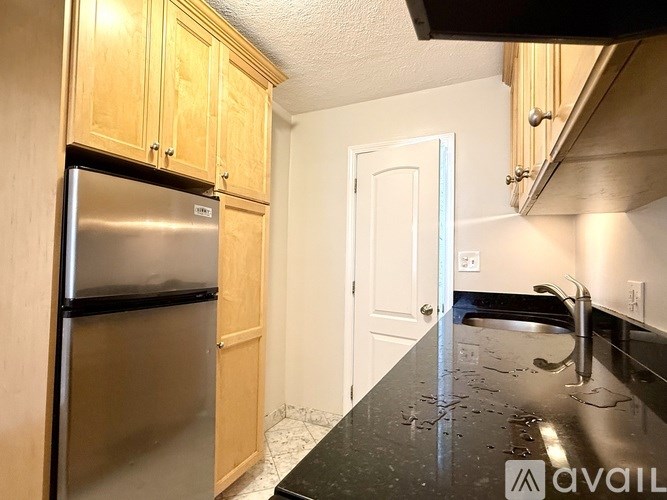 A bathroom with a sink, mirror, and shower curtain.